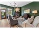 Cozy living room featuring a fireplace, comfortable seating, and stylish green walls at 2630 Milford Ln, Alpharetta, GA 30009
