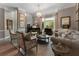 Comfortable living room with a grand piano, bay window, chandelier, and stylish decor at 2630 Milford Ln, Alpharetta, GA 30009