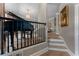 Elegant living room showcasing a grand piano and staircase with black railing at 2630 Milford Ln, Alpharetta, GA 30009