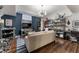 Lively living room with dark hardwood floors, a plush sofa, and shelves for books and toys at 2630 Milford Ln, Alpharetta, GA 30009