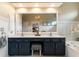 Luxurious main bathroom featuring dual vanities, a large mirror, and elegant finishes at 2630 Milford Ln, Alpharetta, GA 30009