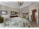 Spacious main bedroom suite with sitting area, tray ceiling, and a doorway leading to additional living space at 2630 Milford Ln, Alpharetta, GA 30009