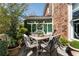 Cozy outdoor dining area with elegant furniture and lush greenery, perfect for relaxing or entertaining guests at 2630 Milford Ln, Alpharetta, GA 30009