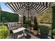 Relaxing outdoor patio with comfortable seating, stylish umbrella, and attractive landscaping at 2630 Milford Ln, Alpharetta, GA 30009