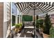 Inviting outdoor patio with a comfortable seating area and stylish black and white umbrella at 2630 Milford Ln, Alpharetta, GA 30009