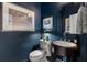 Chic powder room with navy blue walls, designer fixtures, and decorative mirror at 2630 Milford Ln, Alpharetta, GA 30009