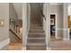Elegant staircase with plush carpeting and stylish railings, leading to the upper level of the home at 2630 Milford Ln, Alpharetta, GA 30009