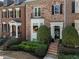 Brick townhouse exterior with neat landscaping, black shutters, and welcoming front entrance at 2630 Milford Ln, Alpharetta, GA 30009