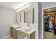 Bathroom with vessel sinks, modern mirrors, and an open walk-in closet at 5775 Stephens Mill Dr, Sugar Hill, GA 30518