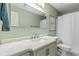 Charming bathroom with a marble countertop vanity, matching toilet, and an elegant light fixture at 5775 Stephens Mill Dr, Sugar Hill, GA 30518