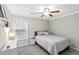 Comfortable bedroom with a neutral color scheme, ceiling fan, window, and ample natural light at 5775 Stephens Mill Dr, Sugar Hill, GA 30518
