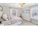 Bright bedroom featuring two large windows, artwork, guitar, and comfortable furnishings at 5775 Stephens Mill Dr, Sugar Hill, GA 30518
