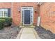 Inviting front entrance with elegant black door, sidelights, and decorative potted plants at 5775 Stephens Mill Dr, Sugar Hill, GA 30518