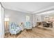 Inviting living room adjacent to dining area, showcasing hardwood floors and elegant furnishings at 5775 Stephens Mill Dr, Sugar Hill, GA 30518