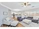 Inviting living room with neutral tones, hardwood floors, and an open layout to the modern kitchen at 5775 Stephens Mill Dr, Sugar Hill, GA 30518