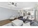 Comfortable living room featuring neutral colors and an open view of the kitchen and stairway at 5775 Stephens Mill Dr, Sugar Hill, GA 30518