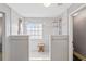 Modern bathroom featuring a dual shower with a window and a stool for comfort at 5775 Stephens Mill Dr, Sugar Hill, GA 30518