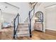 Open foyer with staircase, hardwood floors, and stylish decor creates a welcoming atmosphere at 5775 Stephens Mill Dr, Sugar Hill, GA 30518
