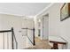 Bright upstairs hallway showcases a small table and leads to a bathroom and bedroom at 5775 Stephens Mill Dr, Sugar Hill, GA 30518