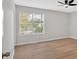 A light and airy bedroom features wood floors, a ceiling fan, and a large window at 111 Evergreen Trl, Cartersville, GA 30121