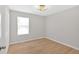 A clean bedroom includes wood floors, a window, and a modern ceiling light at 111 Evergreen Trl, Cartersville, GA 30121