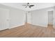 This spacious bedroom features wood floors, three doors, and a ceiling fan at 111 Evergreen Trl, Cartersville, GA 30121