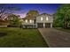 Charming two-story home with a well-manicured lawn, a cozy front porch, and an attached two-car garage at 111 Evergreen Trl, Cartersville, GA 30121