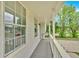 View of the covered porch with gray flooring and white railing for relaxing at 111 Evergreen Trl, Cartersville, GA 30121