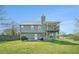 Exterior view of the home highlighting the deck, backyard, and well-maintained lawn at 1218 Cabots Ln, Auburn, GA 30011