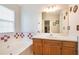 Bright bathroom featuring a large vanity mirror, wood cabinets and decorative tile at 1218 Cabots Ln, Auburn, GA 30011