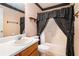 A traditional bathroom with vanity, toilet, and shower/tub with patterned curtain at 1218 Cabots Ln, Auburn, GA 30011