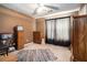 Cozy carpeted bedroom with a ceiling fan, closet and large window with curtains at 1218 Cabots Ln, Auburn, GA 30011