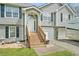 View of the home's front entrance with stairs, a white door, manicured lawn, and RV Parking at 1218 Cabots Ln, Auburn, GA 30011