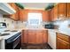 The kitchen features white appliances, wood cabinets, ample countertop space, and a window at 1218 Cabots Ln, Auburn, GA 30011