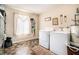 Functional laundry room equipped with washer, dryer, and ample natural light at 1218 Cabots Ln, Auburn, GA 30011