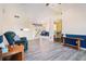 View of the living room featuring wood-look vinyl floors, wainscotting, and a vaulted ceiling at 1218 Cabots Ln, Auburn, GA 30011