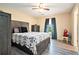 Comfortable main bedroom with a ceiling fan, wood-look floors and neutral colored walls at 1218 Cabots Ln, Auburn, GA 30011