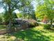 Aerial view of a home with a spacious yard, mature trees, deck, and privacy fence at 1629 Anita Ne Pl, Atlanta, GA 30306