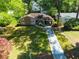 Inviting single-story home with well-maintained lawn, private driveway, and mature shade trees at 1629 Anita Ne Pl, Atlanta, GA 30306