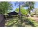 Spacious yard featuring mature trees, green lawn, and a wooden deck and lattice fence for privacy at 1629 Anita Ne Pl, Atlanta, GA 30306