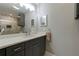 Contemporary bathroom boasts a granite-look vanity, a framed mirror, and modern lighting at 1629 Anita Ne Pl, Atlanta, GA 30306