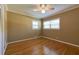 Bedroom featuring hardwood floors, crown molding, two windows, and a ceiling fan at 1629 Anita Ne Pl, Atlanta, GA 30306