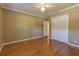 Bedroom with hardwood floors, crown molding, ceiling fan, and spacious closet for storage at 1629 Anita Ne Pl, Atlanta, GA 30306