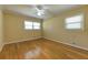 Bedroom with hardwood floors, natural light, a ceiling fan, and simple neutral-colored walls at 1629 Anita Ne Pl, Atlanta, GA 30306
