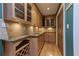 Butler's pantry features under-cabinet lighting, wine rack, granite counters, hardwood floors, and ample storage at 1629 Anita Ne Pl, Atlanta, GA 30306