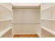 A bright walk-in closet features wood floors and a variety of shelves and hanging rods at 1629 Anita Ne Pl, Atlanta, GA 30306