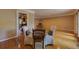 Dining area features hardwood floors, glass table with upholstered chairs, and view into kitchen and Gathering room at 1629 Anita Ne Pl, Atlanta, GA 30306