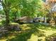 Beautiful single-story home with verdant lawn, blooming flowers, and a tranquil, tree-filled setting at 1629 Anita Ne Pl, Atlanta, GA 30306
