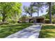 Lovely single-story home featuring a well-manicured lawn, blooming shrubs, and convenient carport at 1629 Anita Ne Pl, Atlanta, GA 30306