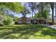 Charming single-story home boasts a lush green lawn, mature trees, and a convenient attached carport at 1629 Anita Ne Pl, Atlanta, GA 30306